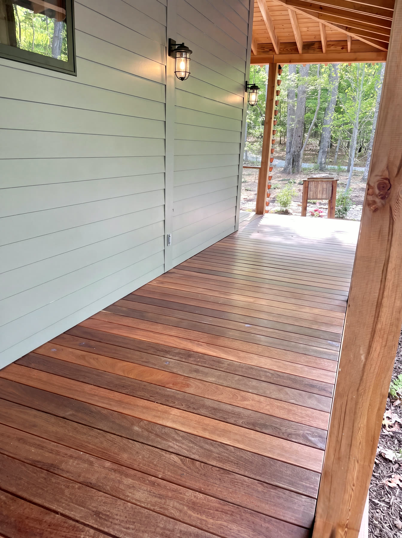 Custom modern mountain home with wraparound ipe-decked porch on a wooded Cumberland Plateau lake lot