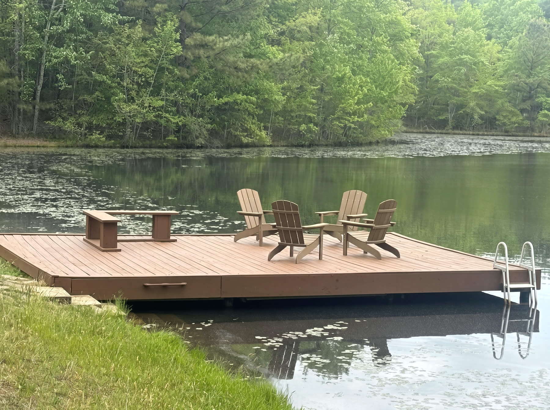 Custom lakeside dock with built-in bench on a quiet wooded Cumberland Plateau pond